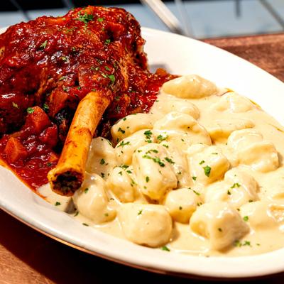 Braised lamb shank served with gnocchi.