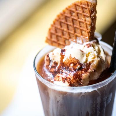 Chocolate cocktail, with whipped cream and a biscuit, closeup