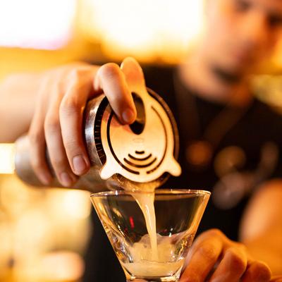 A hand pouring a drink.