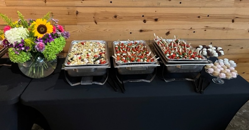 A buffet setup at an event featuring a variety of appetizers and desserts