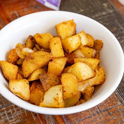 Bowl of spiced fried potatoes.