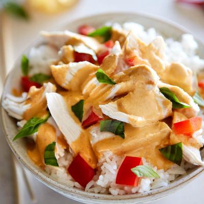 Creamy chicken over rice with red peppers and basil.