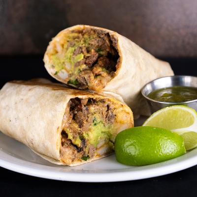 California burrito served with salsa and lime wedges.
