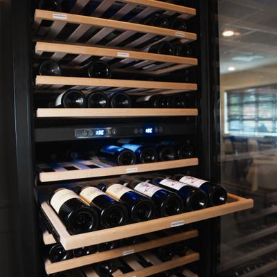 Wooden racks with wine bottles.