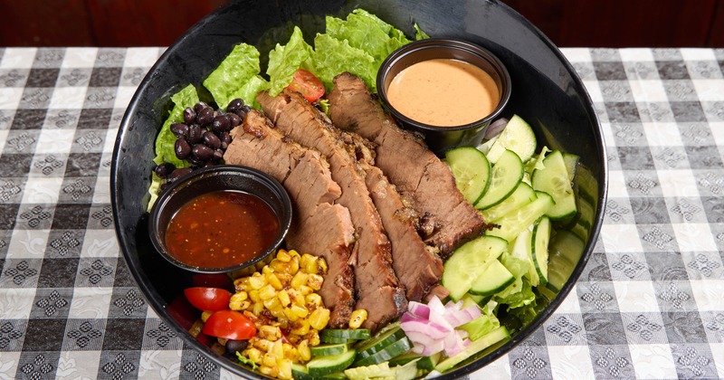Brisket salad bowl with vegetables and two dressings