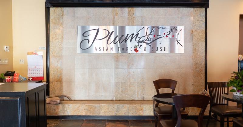 Interior, front desk area, Plum Asian Fare and Sushi sign on a wall