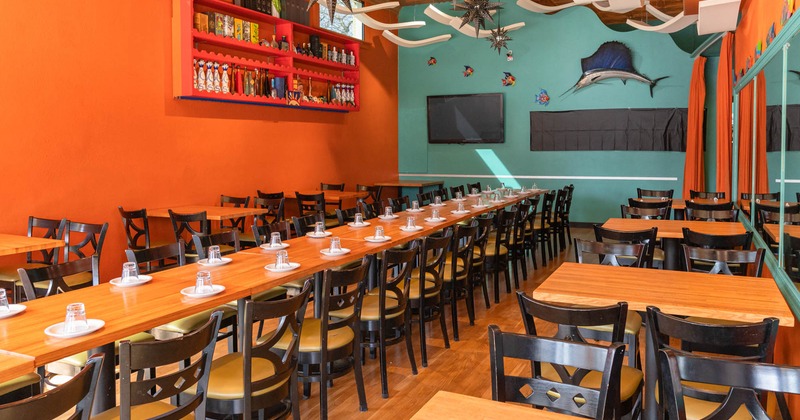 Interior, seating area, long table setup for 30 plus people, tables for four on the sides