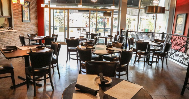 Cozy interior dining area with wooden tables and upholstered chairs