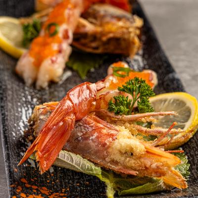 Grilled shrimp served with lemon wedges and fresh herb garnish.