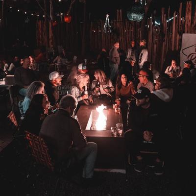 Customers sitting around the fire pit.