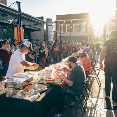 People gathered around tables at the outdoor event.