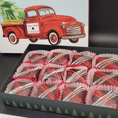 A festive box of chocolate cakes with an illustration of a vintage red truck behind.