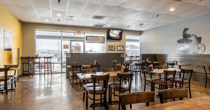 Interior, dining area, wooden top tables for two and four,  banquette bench with tables