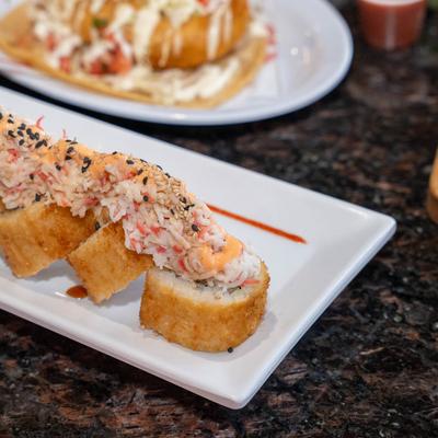 Crispy sushi roll topped with crab, spicy mayo, and sesame seeds.
