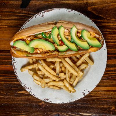 Salmon Cheesesteak with avocado and fries.
