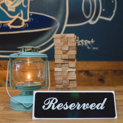 Reserved sign with a tumbling tower and a candle lantern.