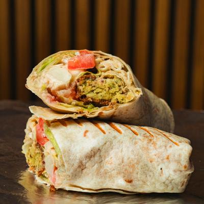 Falafel Veg Wrap, sliced in half and served.