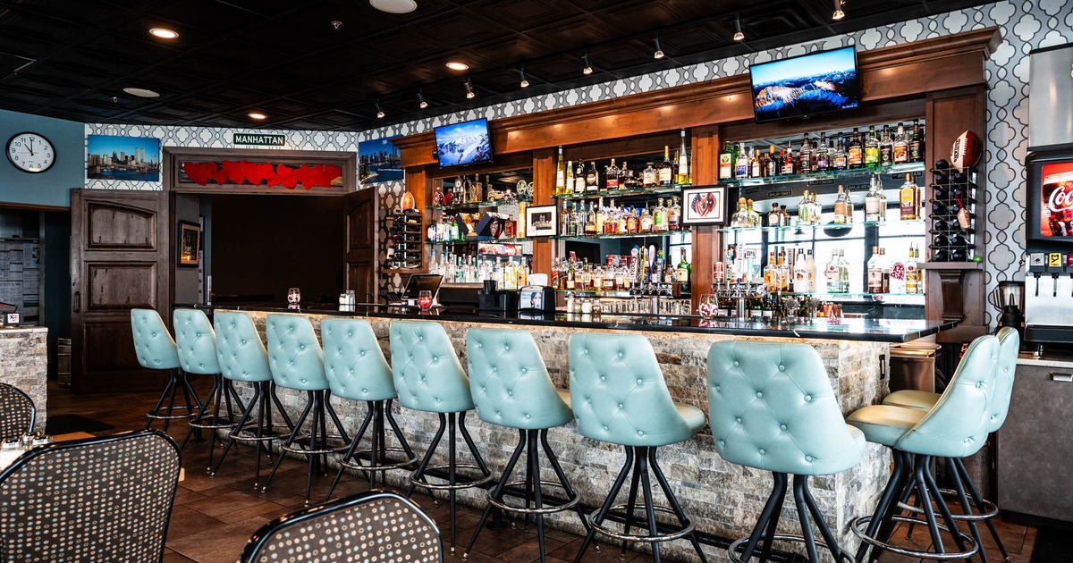 Interior, bar area, marble top bar with pleather padded stools, large drink shelf