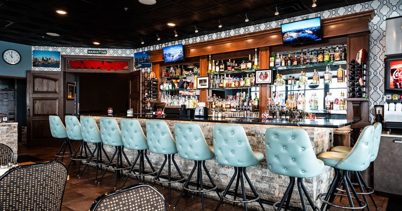 Interior, bar area, marble top bar with pleather padded stools, large drink shelf