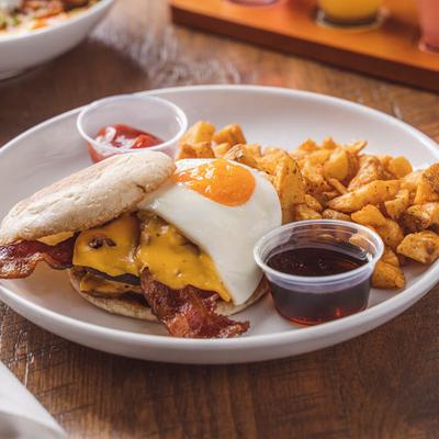 Breakfast burger with home fries and dipping sauces