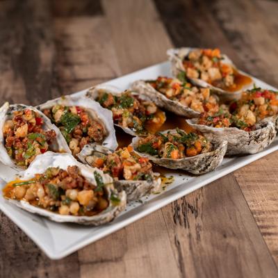 Chef's Special Steamed Oysters served on the half-shell and topped with a savory mixture.