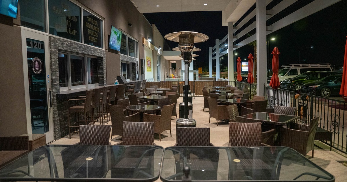 Exterior, patio with lined up tables and chairs