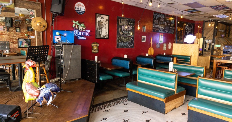 Interior, tables and benches with blue leather cushion, small stage on the left