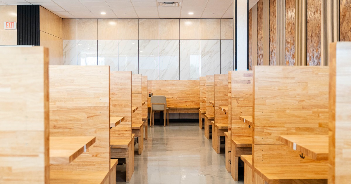 Modern dining area with wooden booths arranged in rows