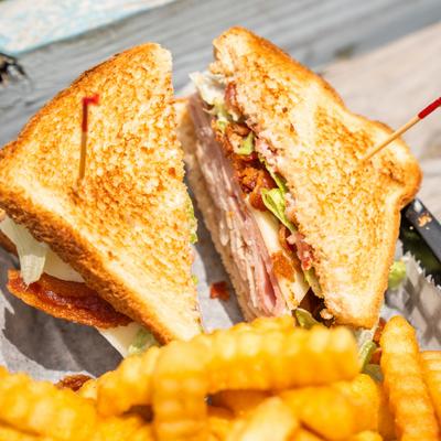 Club sandwich paired with fries.