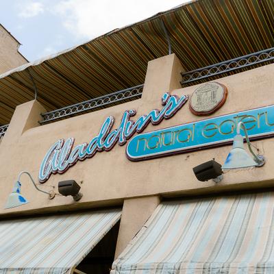 Storefront featuring blue signage and white awning.