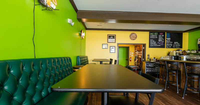Interior, order counter area, button tufted seating with tables and chairs