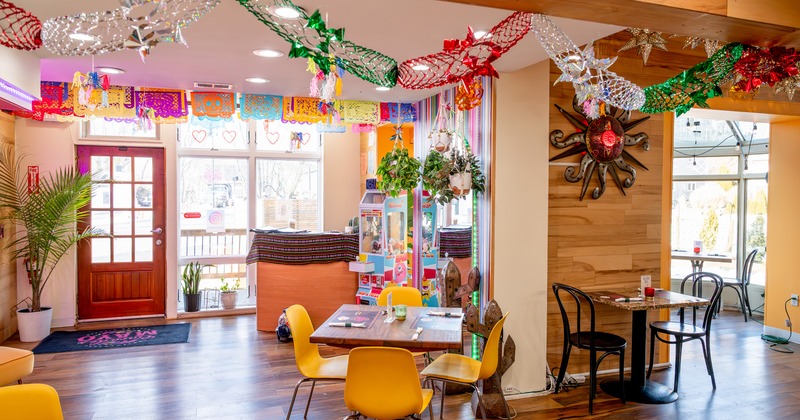 Bright and colorful restaurant interior seating area with a modern Mexican-style design