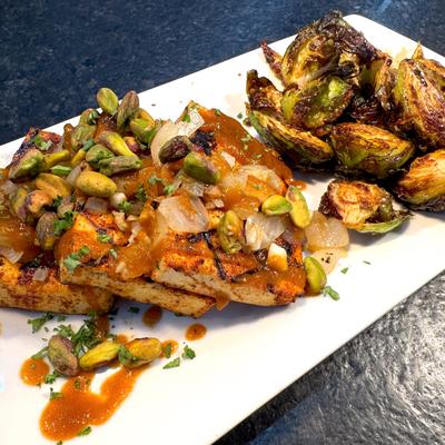 Indian spice rubbed grilled tofu topped with pistachios, served with brussels sprouts.