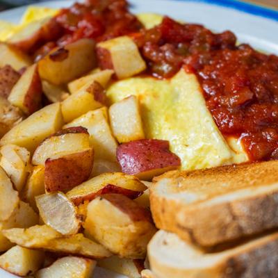 Mexican omelet, potatoes, and toast, closeup.