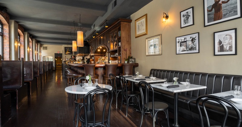 Cozy restaurant interior with booths, and round tables