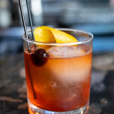 Old Fashioned garnished with lemon peel and a cherry.