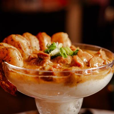 Shrimp Sausage and Grits served in margarita glass.