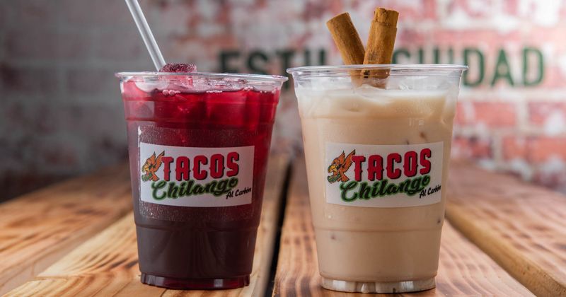 Colorful drinks with tacos logo the glass