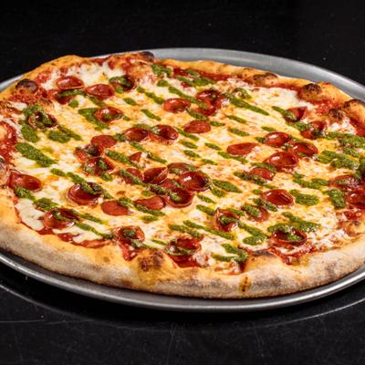 Pepperoni and pesto pizza.