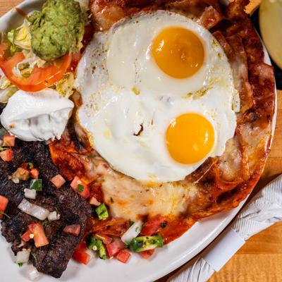 Eggs over chilaquiles with assorted sides.
