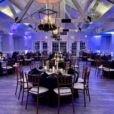 Reception hall glowing with blue uplighting.