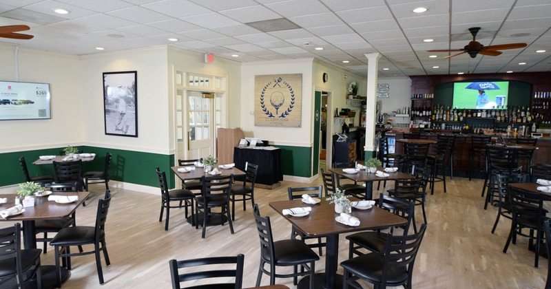 Interior, dining area, wooden top tables, ready for guests, bar in the back