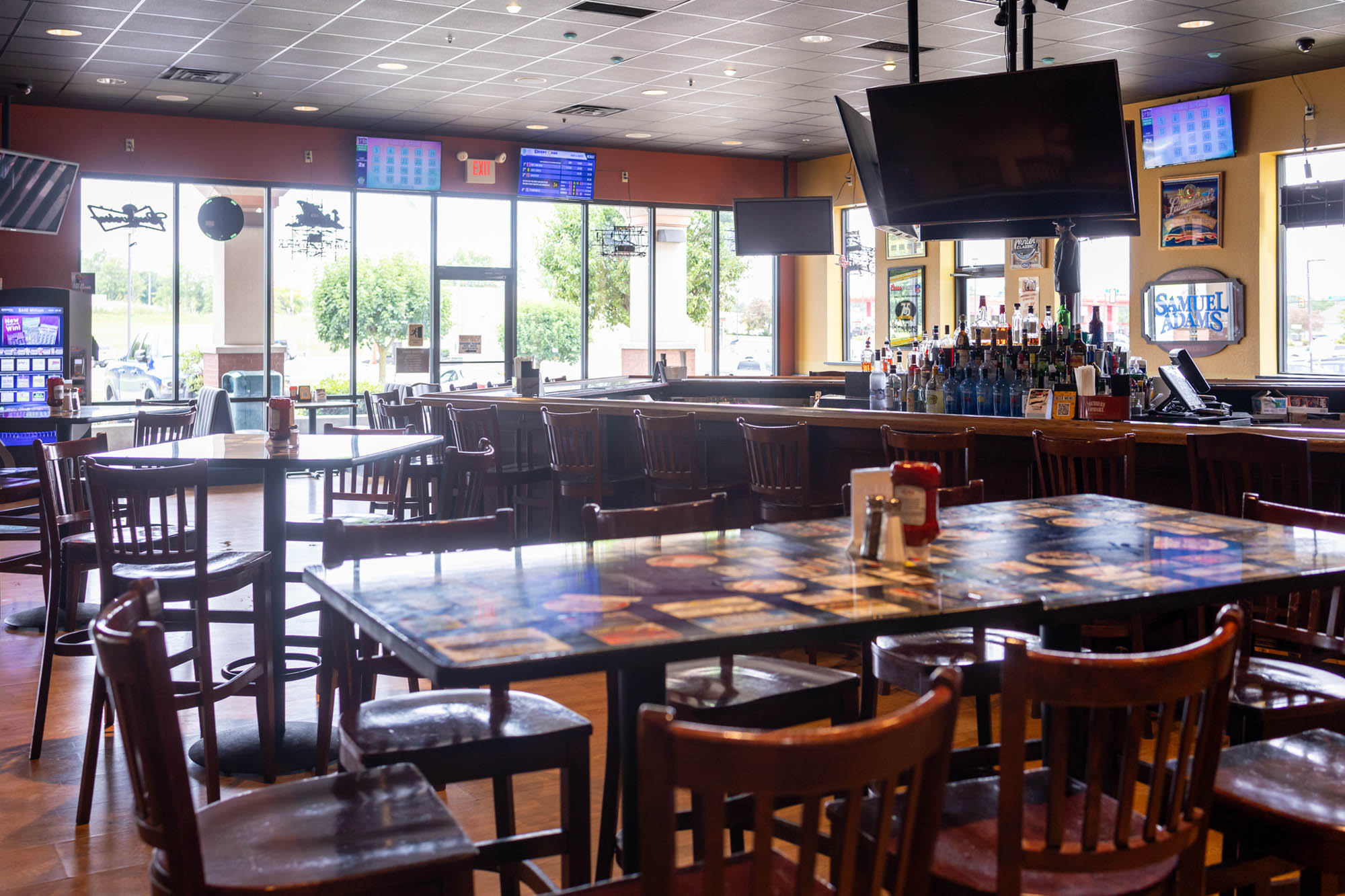 Diner room, tables and chairs, seating place with tv's above