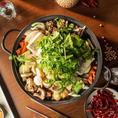 Korean-style hot pot with tofu, various vegetables and herbs.