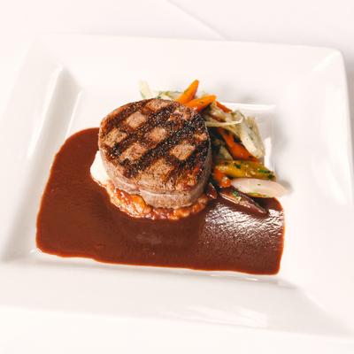 Beef tenderloin in sauce with vegetables.