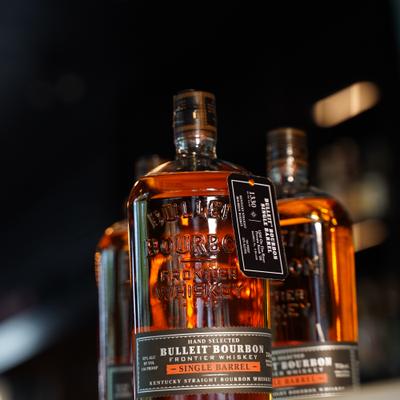 Three bottles of bourbon whiskey displayed on the counter.
