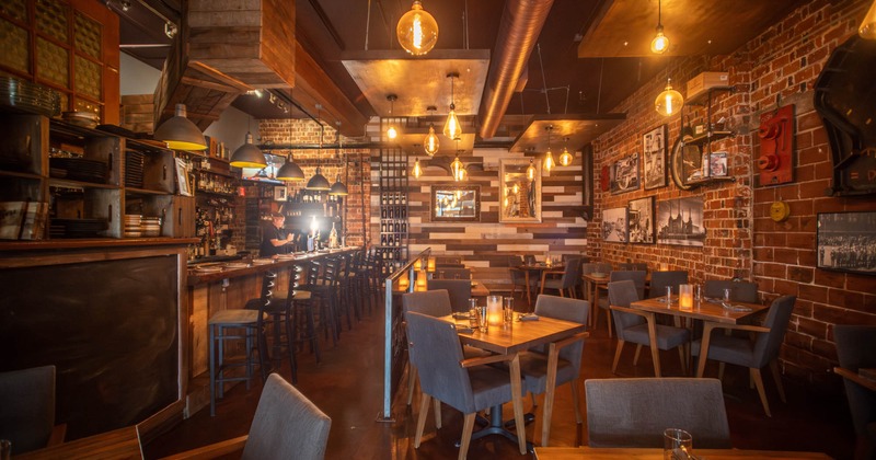 Interior, tables and chairs on the right, bar and bar stools on the left