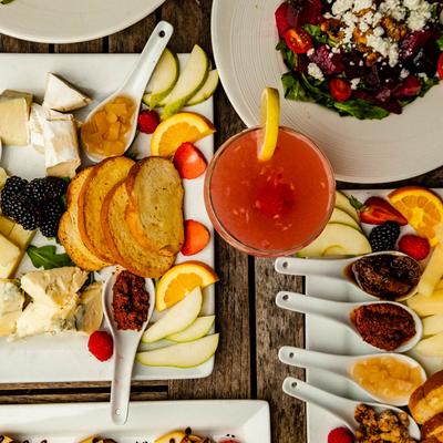 Multiple food plates and a drink, top view