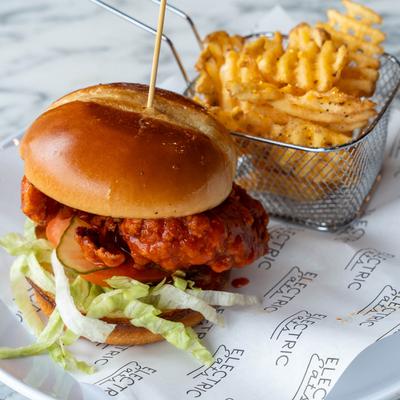 Spicy fried chicken sandwich, with waffle fries on the side.