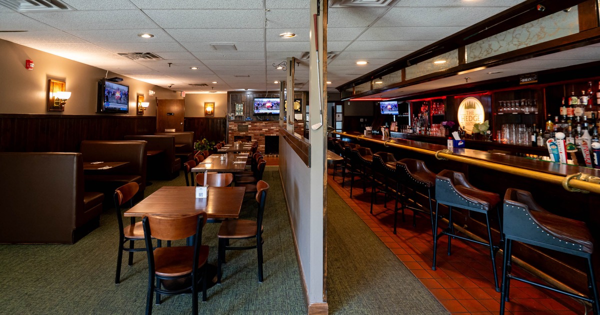 Interior of a restaurant with a dining area on the left and a bar on the right